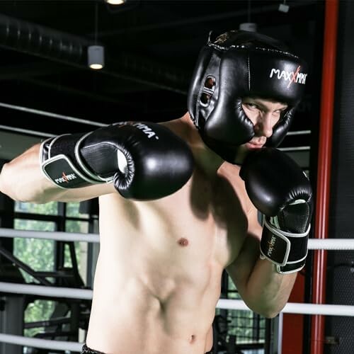 Boxer wearing gloves and headgear in a gym