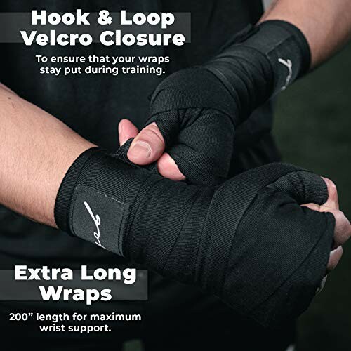 Close-up of hands with black boxing wraps featuring hook and loop Velcro closure.