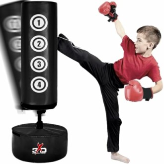 Child practicing martial arts with a punching bag.