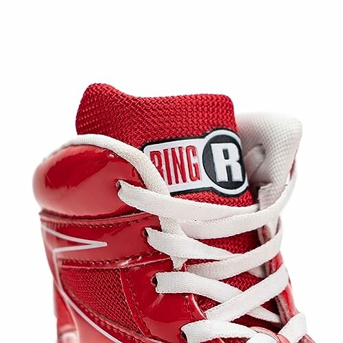 Close-up of a red wrestling shoe with white laces.